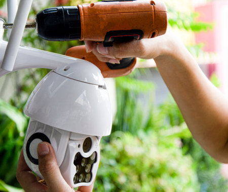 Man installing IP CCTV or high tech surveillance system CCTV systemの写真素材