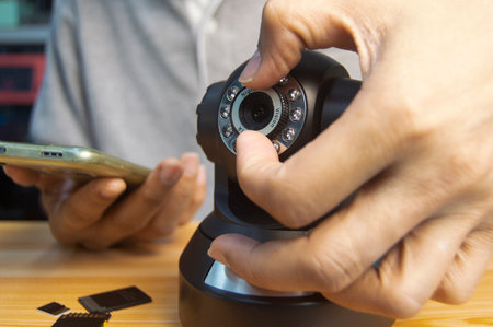 Conceptual man operating ip camera