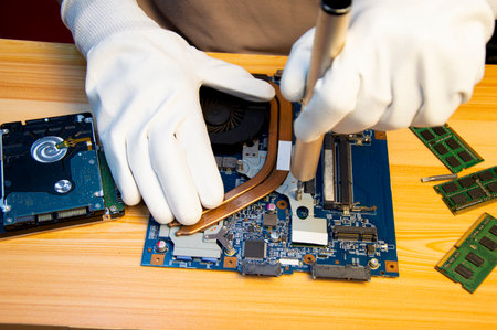 Technician repairing computer motherboard, notebook motherboardの写真素材
