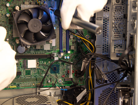 side view technician repairing computerの写真素材