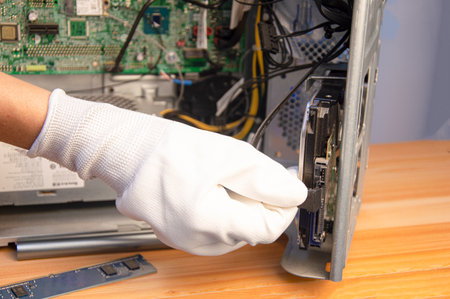 side view technician repairing computerの写真素材