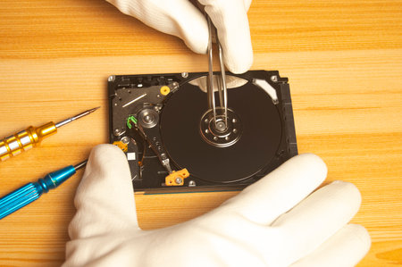 Top view of mechanic repairing hard driveの写真素材