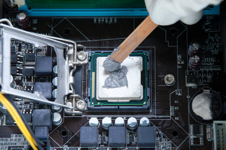 Top view Technician applying silicone Cooling on CPU chipsの写真素材