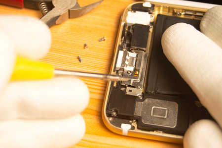 Top view of a technician repairing a smartphoneの写真素材