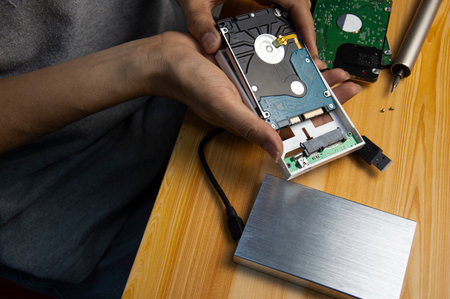 top view, man assembling an external hard driveの写真素材