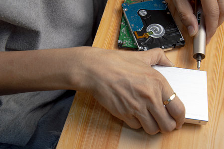 top view, man assembling an external hard driveの写真素材