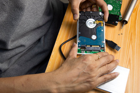 top view, man assembling an external hard driveの写真素材