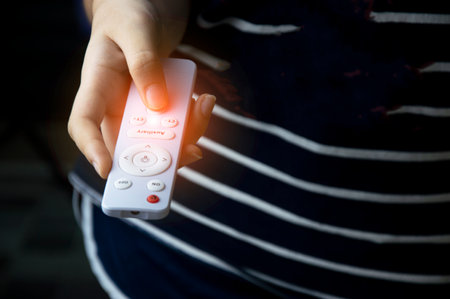 White tone remote control, woman using remote control