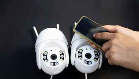 White IP camera, technician setting up camera operationの写真素材