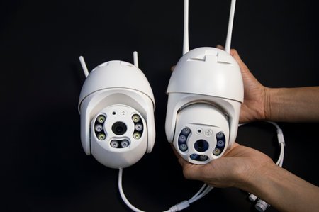 Two white IP cameras placed on a black backgroundの写真素材