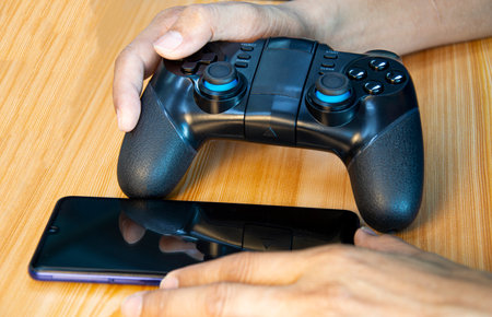 Front view of gaming device joystick placed on wooden floor
