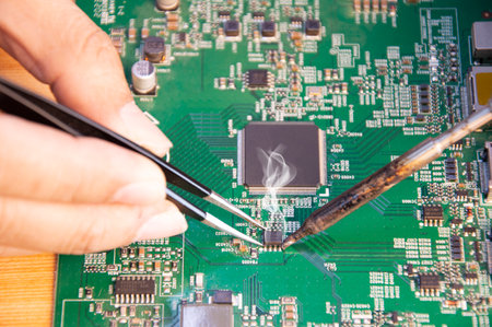 top view, mechanic repairing motherboard, solderingの写真素材