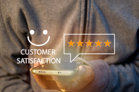 close up Man hand using smartphone with popup five star icon for feedback review satisfaction service, Customer service experience and business satisfaction survey.の写真素材