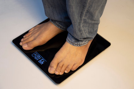 standing on the indoor scales There is space for text. The problem of being overweight or underweightの写真素材