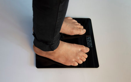 standing on the indoor scales There is space for text. The problem of being overweight or underweightの写真素材