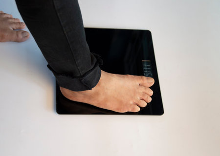 standing on the indoor scales There is space for text. The problem of being overweight or underweightの写真素材
