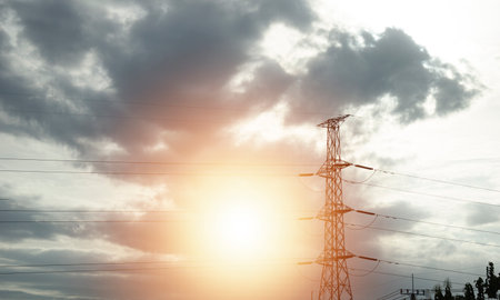 High voltage towers at sunset background. Power lines against the sky
