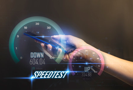 fast internet connection speedtest network bandwidth technology Man using high speed internet with smartphone and laptop computer. 5G quality, speed optimizationの写真素材