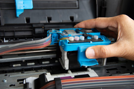 Technician repairing printer, fixing printer head