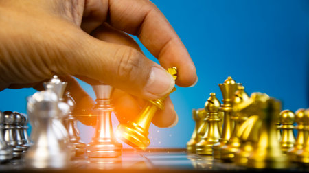 Concept, Image of confident hand of businessman moving chess pieces in competition for success in...