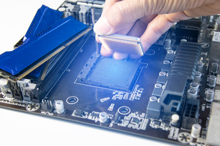 The technician is installing the CPU onto the motherboard.の写真素材