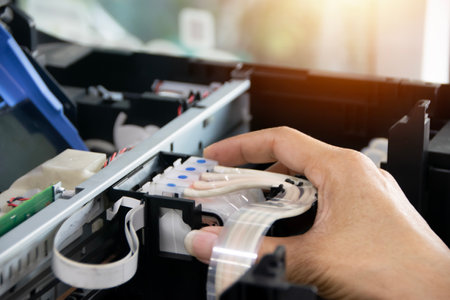 The technician is aligning the print head and repairing the printer.の写真素材