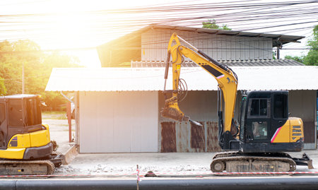 A mini excavator is working on a construction site.の写真素材