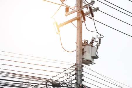 Large power transformers mounted on polesの写真素材