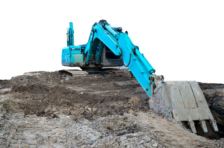 A large excavator is working in a workplace, isolated on a white background.