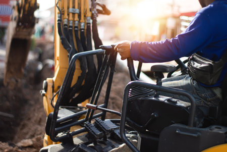 The excavator driver is controlling the operation of the vehicle.の写真素材
