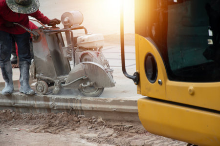Workers are using machinery to cut concrete floors.の写真素材