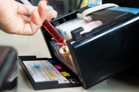 Top view of printer filling with yellow ink.
