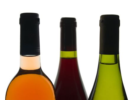 Backlit shot of red, rose and white wine bottlesの写真素材
