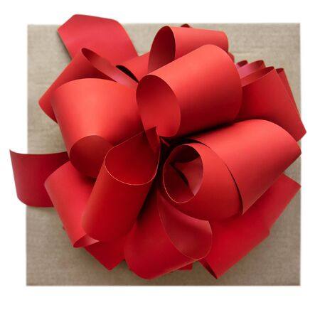 Large red bow on a box, on a white background, top view. Beautiful festive bow for gift, gift wrapping, banner, advertisement, congratulation.の写真素材
