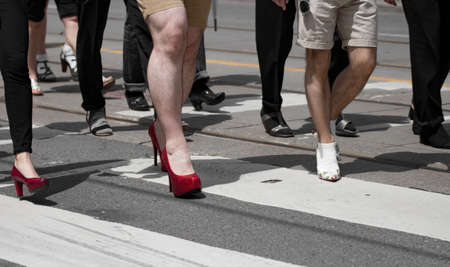 Feet of a group of men walking in women's shoes with The International Men's March Against Gender Violence, Toronto, Canadaのeditorial素材
