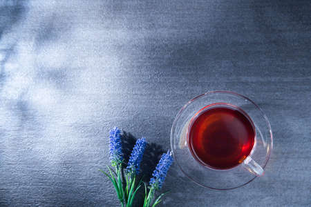 Tea in a light-filled clear glass. Healing, rest, cafe, tea time.の写真素材