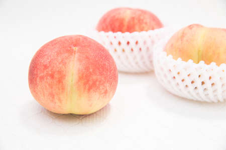 Three ripe fruit japanese peaches.