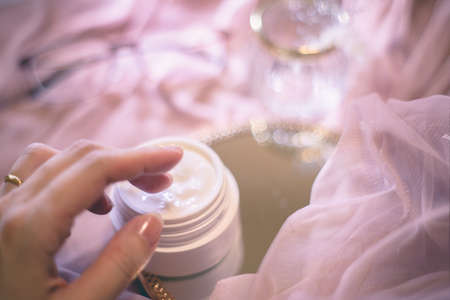 Apply moisturizing cream. Women's hands, beauty, skin care, texture.の写真素材