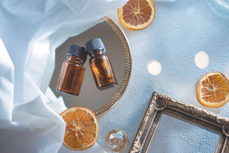 Aroma material. Two bottles of aroma oil. Dried fruit orange.の写真素材