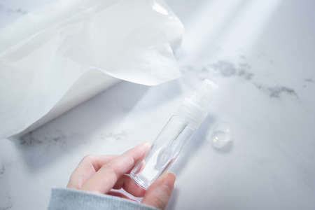 A state of holding a portable disinfectant spray in the room.
