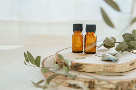 Wood and two aromatic oil bottles. Images of nature, organics and beauty.の写真素材