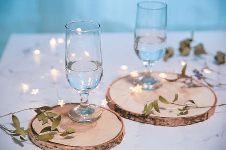 Drink glasses and glitter illumination. Party, home time and table photos.