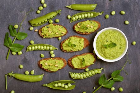Sandwiches with pesto sauce and pine nuts. Fresh green peas, top viewの写真素材