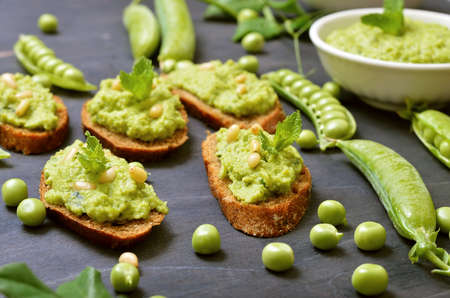 Sandwiches with pesto sauce and pine nuts. Fresh green peas, close upの写真素材