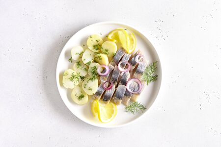 Sliced herring fish with boiled potatoes. Russian cuisine. Top view, flat layの写真素材