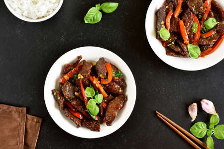 Thai beef stir-fry with pepper and basil in bowl. Top view, flat layの写真素材