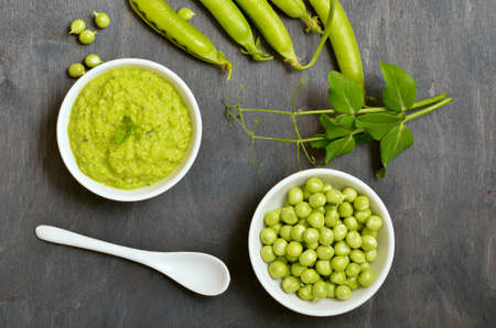 Fresh green peas in bowl and homemade green pea puree. Top view, flat lay