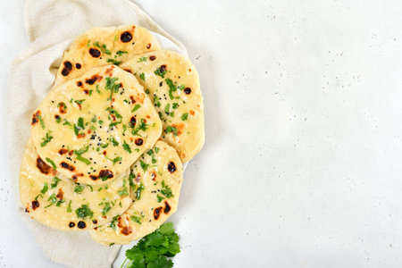 Indian naan bread over light background with copy space. top view, flat layの写真素材