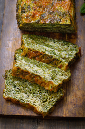 Slices of spinach bread on wooden cutting boardの写真素材