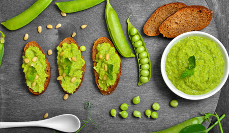 Sandwiches with pesto sauce and pine nuts. Fresh green peas. Top view, flat layの写真素材